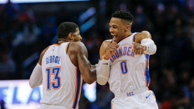 Feb 11, 2019; Oklahoma City, OK, USA; Oklahoma City Thunder guard Russell Westbrook (0) and forward Paul George (13) celebrate after Westbrook hit a three-point basket during the second half at Chesapeake Energy Arena. Oklahoma City won 120-111. Mandatory Credit: Alonzo Adams-USA TODAY Sports